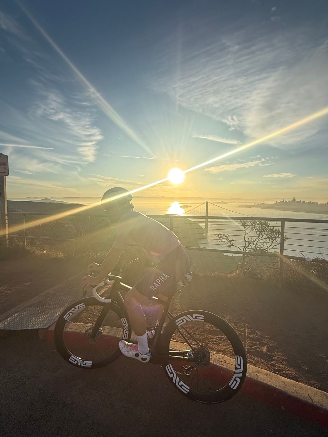Frenk riding his road bike at sunrise above the Golden Gate Bridge